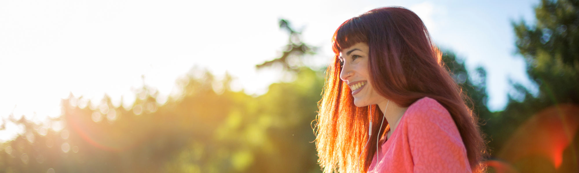 Girl listening to music with headphones and smiling