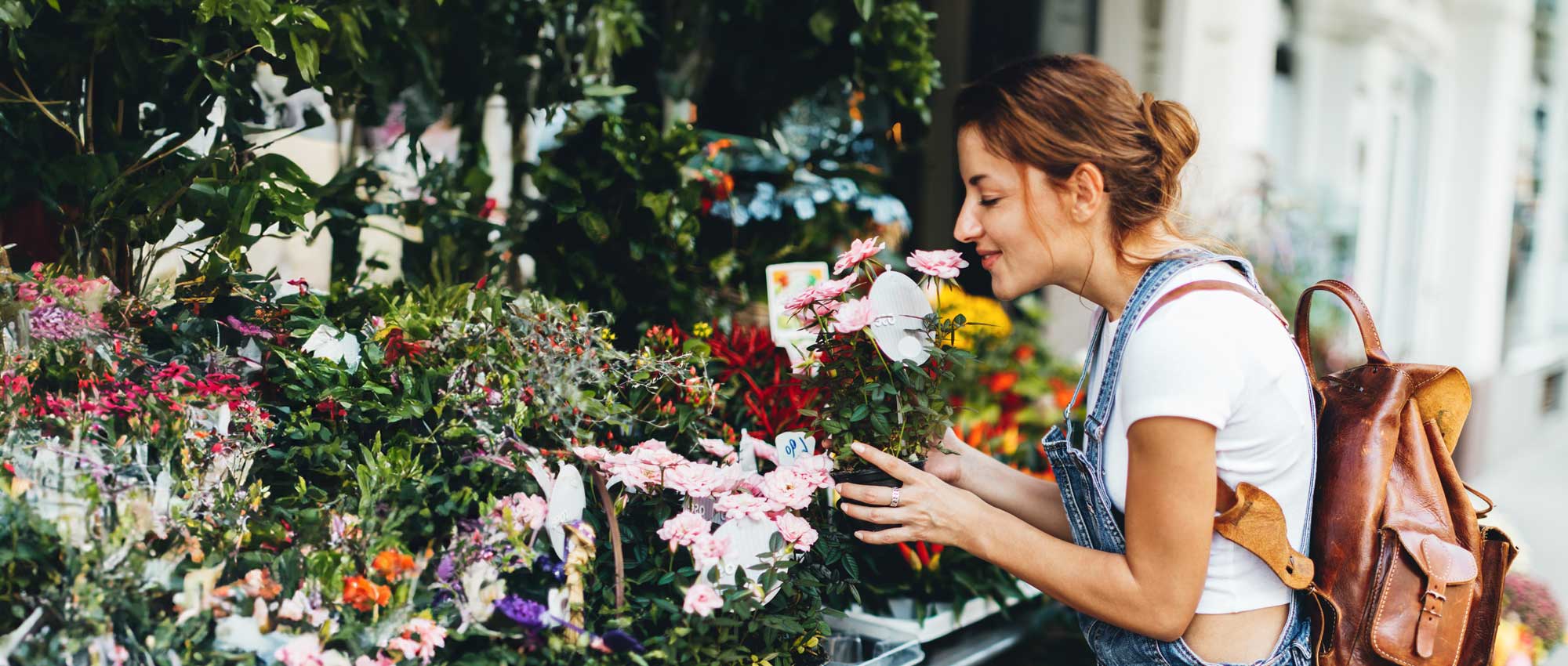A young girl smelling a bouquet of flowers